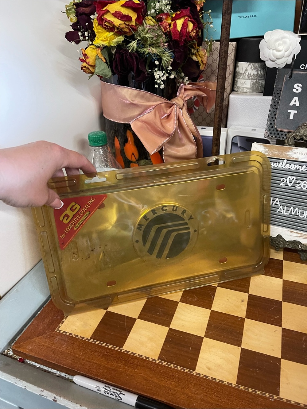 Au-Tomotive Gold mercury vanity license plate featuring a 3D emblem logo.
